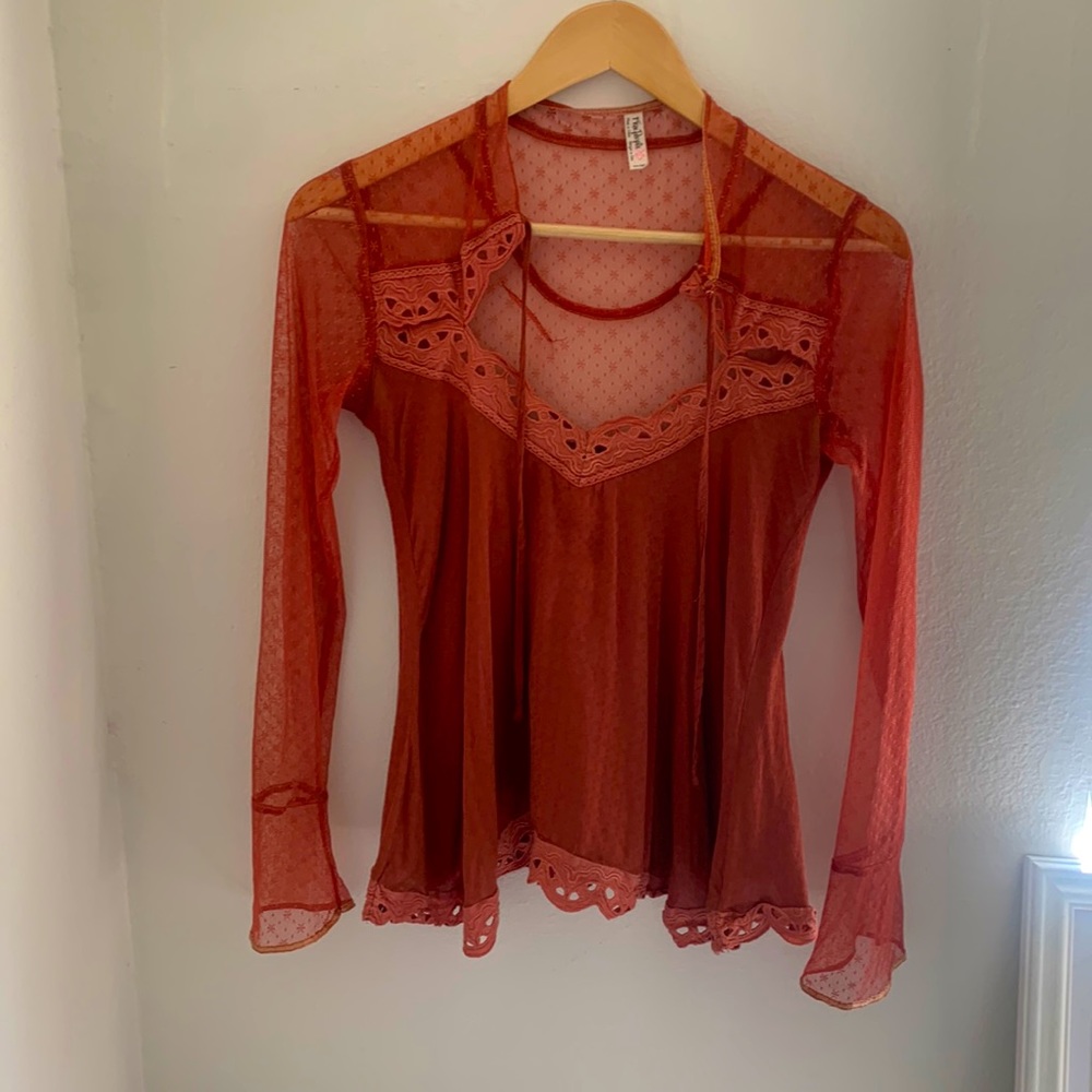 Long sleeve lace blouse by Free People, size XS. Ties in front.